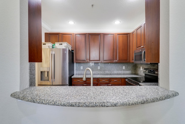 kitchen featuring stainless steel appliances, sink, kitchen peninsula, light stone counters, and tasteful backsplash