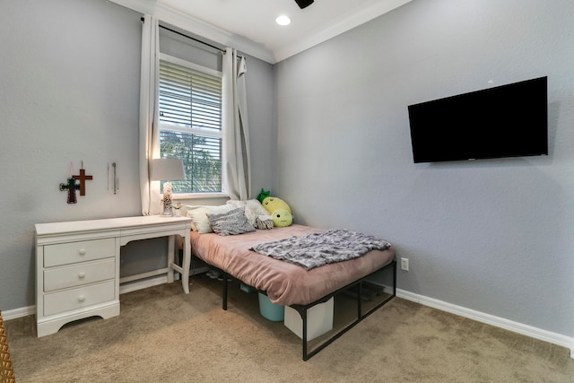 carpeted bedroom with ceiling fan and crown molding