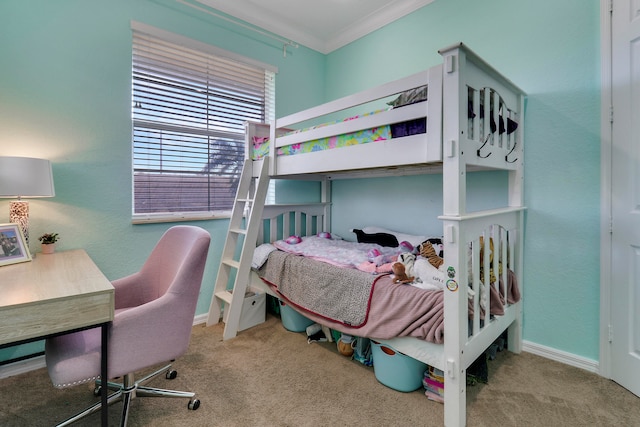 bedroom with ornamental molding and light colored carpet