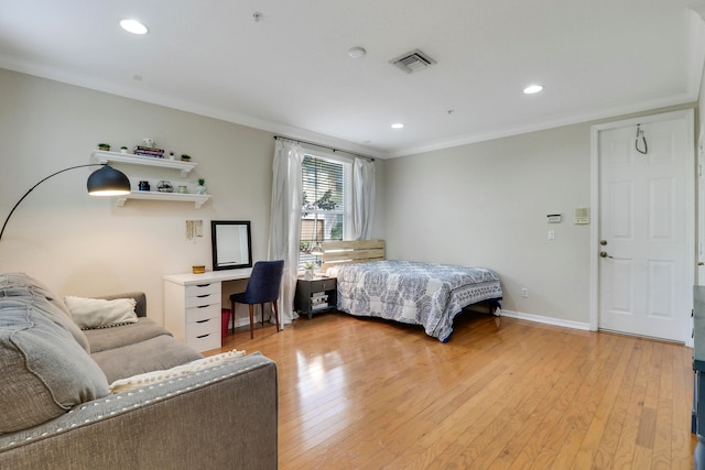 bedroom featuring ornamental molding and light hardwood / wood-style flooring