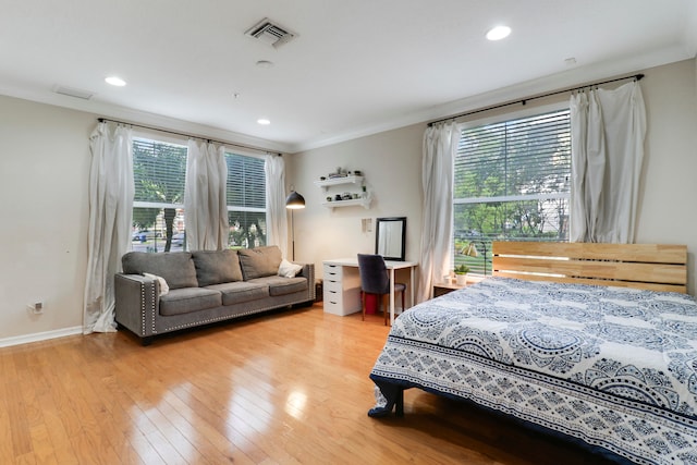 bedroom with hardwood / wood-style flooring and ornamental molding