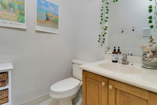 bathroom featuring toilet, lofted ceiling, vanity, and tile patterned floors