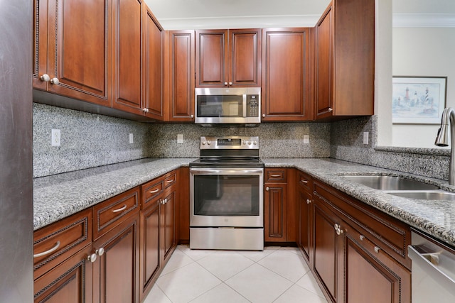 kitchen with light stone counters, crown molding, appliances with stainless steel finishes, decorative backsplash, and sink