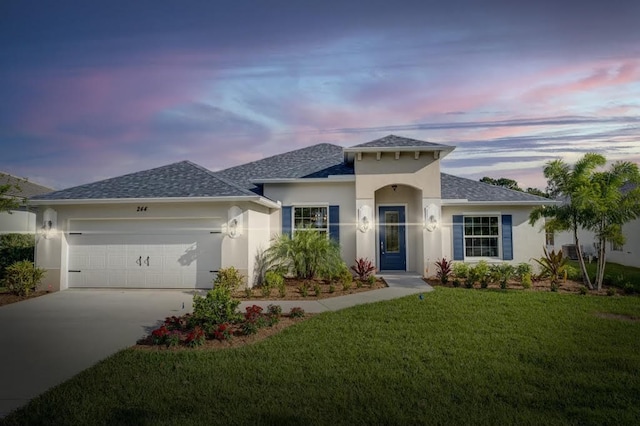 view of front of home with a lawn and a garage