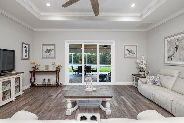 living room featuring hardwood / wood-style floors, ceiling fan, and ornamental molding