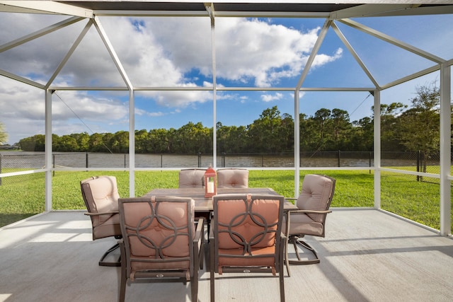 sunroom / solarium featuring a water view