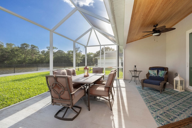 view of patio featuring glass enclosure and ceiling fan