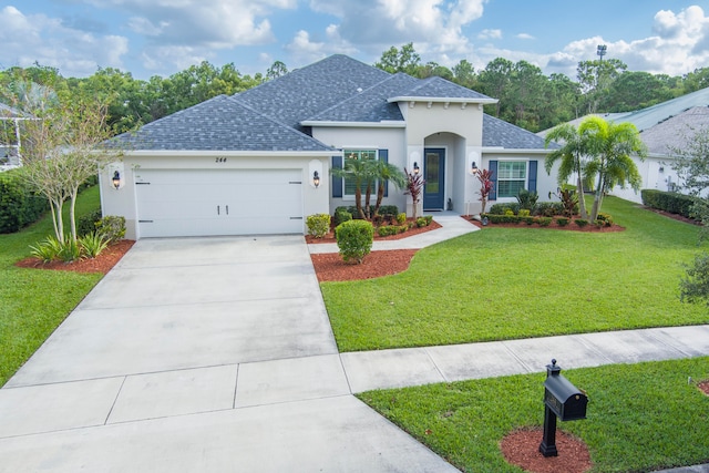 view of front of home with a garage and a front lawn