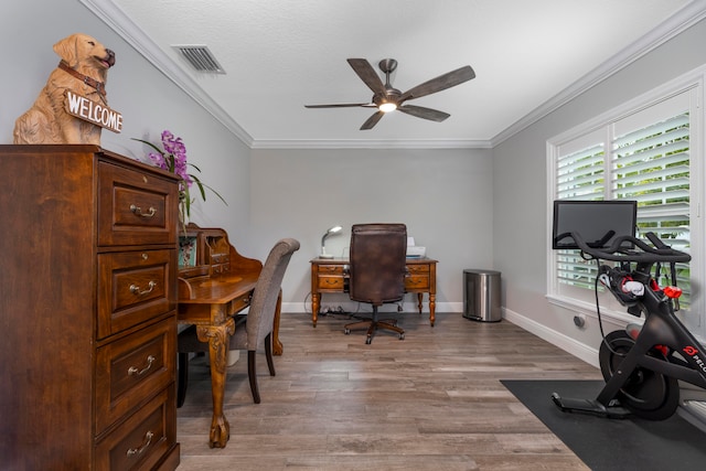 home office featuring hardwood / wood-style flooring, ceiling fan, ornamental molding, and a textured ceiling