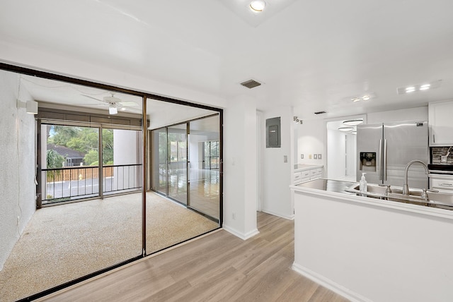 kitchen featuring light hardwood / wood-style floors, white cabinetry, tasteful backsplash, ceiling fan, and stainless steel fridge with ice dispenser