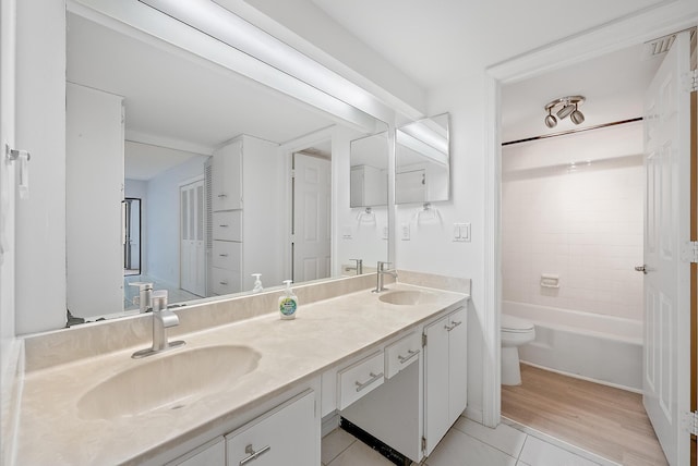 full bathroom with toilet, shower / tub combination, vanity, and hardwood / wood-style floors