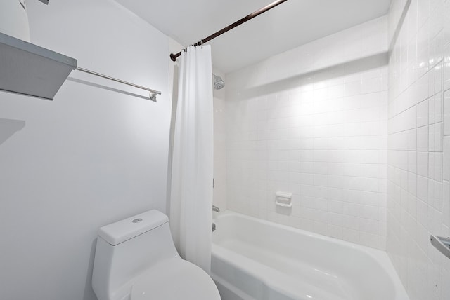 bathroom with shower / tub combo with curtain and toilet