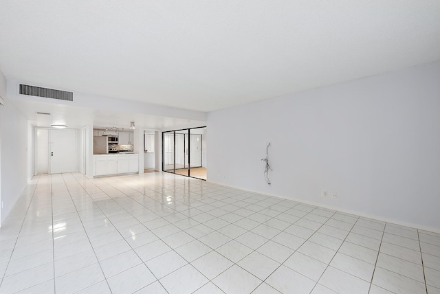 unfurnished living room featuring light tile patterned floors