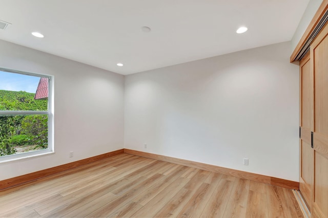 spare room featuring light wood-type flooring