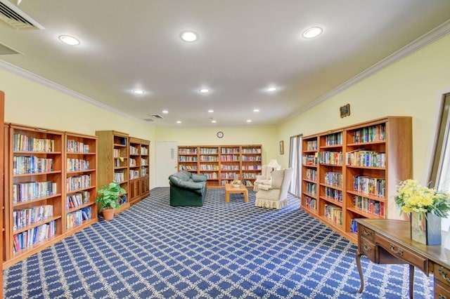 sitting room with ornamental molding and carpet flooring