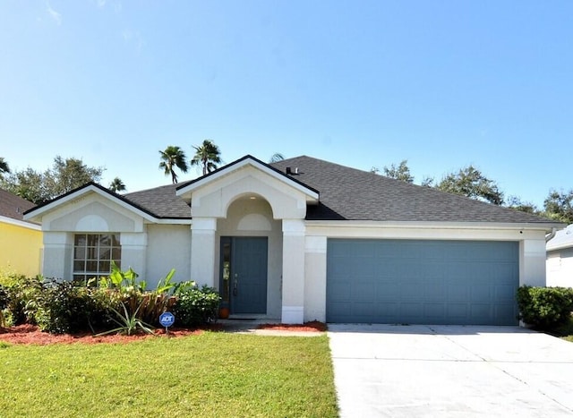 ranch-style house with a garage and a front yard