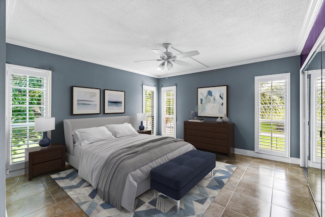 bedroom with ceiling fan, light tile patterned floors, a textured ceiling, and ornamental molding