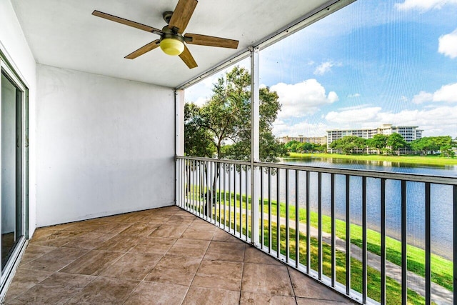 balcony featuring ceiling fan and a water view