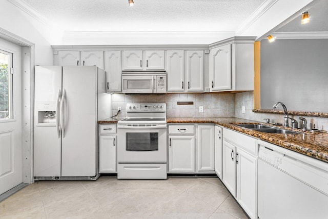 kitchen featuring a textured ceiling, white cabinetry, sink, and white appliances