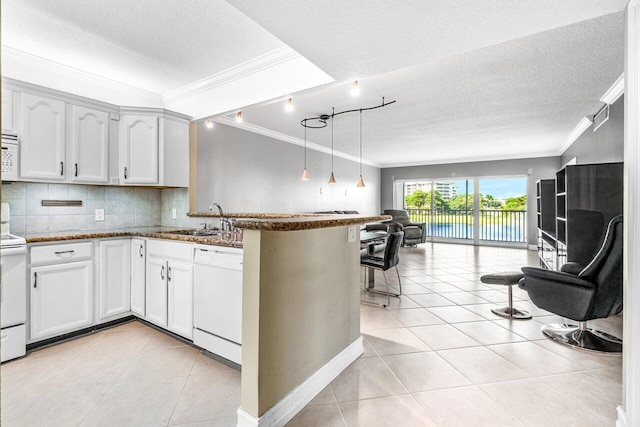 kitchen featuring kitchen peninsula, sink, white cabinets, and white appliances