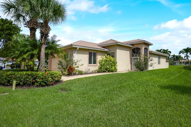 mediterranean / spanish-style home featuring a front lawn