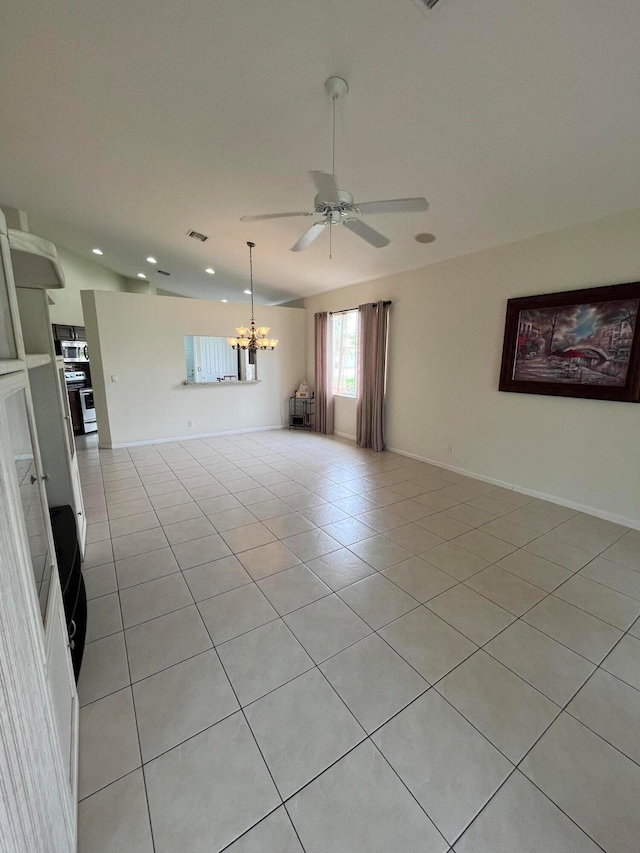 tiled spare room with ceiling fan with notable chandelier