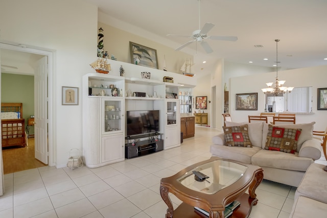 tiled living room featuring ceiling fan with notable chandelier and high vaulted ceiling