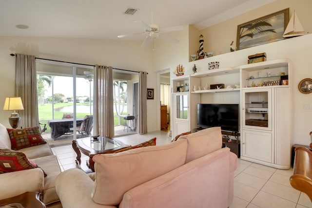 living room featuring lofted ceiling, ceiling fan, and light tile patterned floors