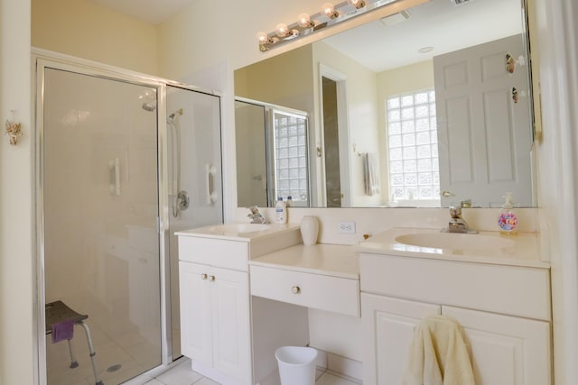 bathroom with vanity, a shower with door, and tile patterned floors