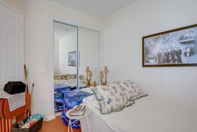 bedroom featuring hardwood / wood-style floors and a closet