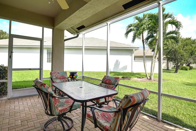 sunroom featuring ceiling fan