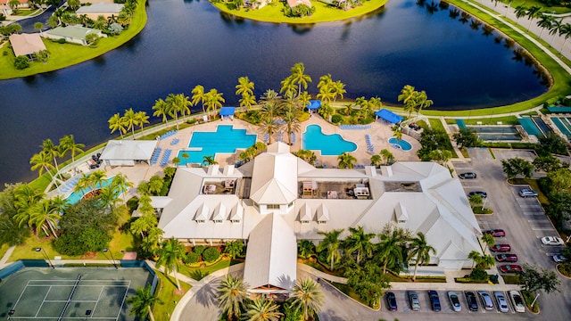 birds eye view of property with a water view