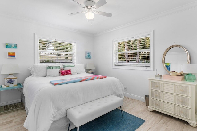 bedroom with ceiling fan, light hardwood / wood-style flooring, and crown molding