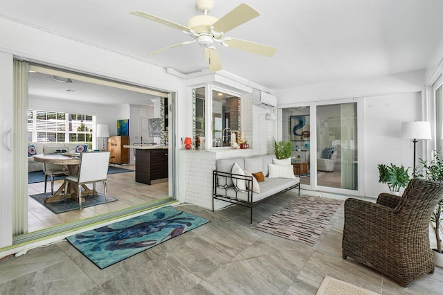 sunroom / solarium with an AC wall unit and ceiling fan