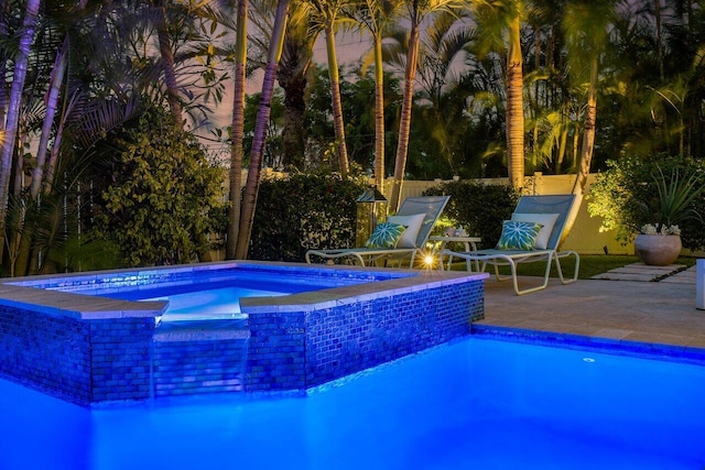 view of pool featuring an in ground hot tub and a patio