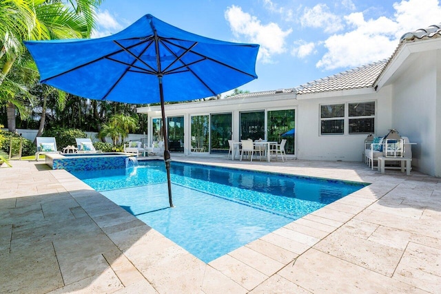 view of swimming pool with a patio area and an in ground hot tub