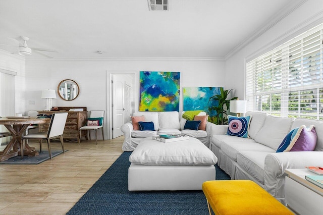 living room featuring ceiling fan, light wood-type flooring, and ornamental molding