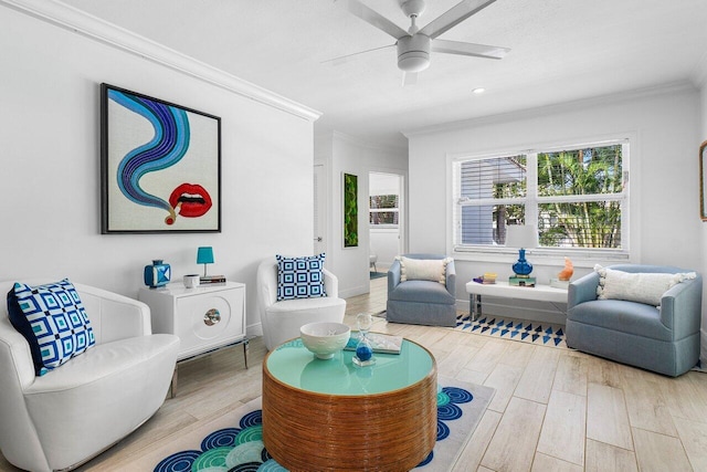 living room featuring hardwood / wood-style floors, ceiling fan, and ornamental molding