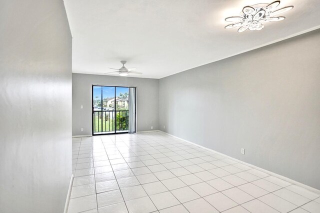 tiled spare room with ceiling fan