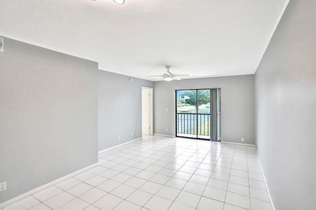 unfurnished room with ceiling fan and light tile patterned flooring