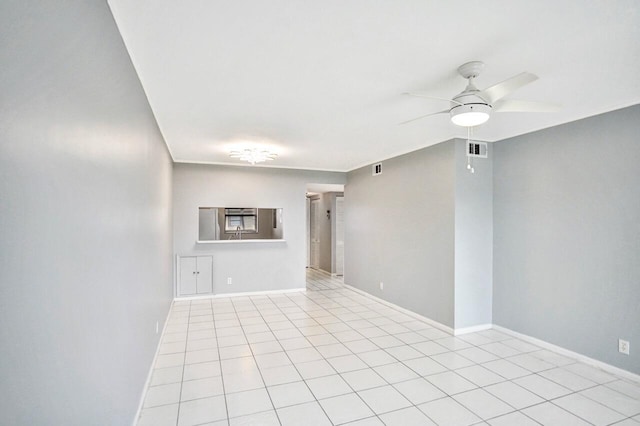 spare room with ceiling fan and light tile patterned flooring