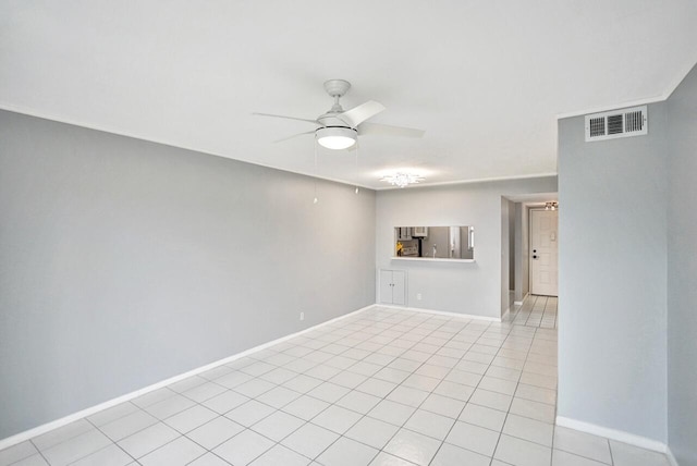 spare room with ceiling fan and light tile patterned flooring