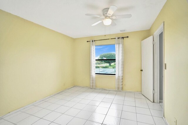 empty room with light tile patterned floors and ceiling fan