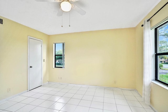 unfurnished room with ceiling fan and light tile patterned floors