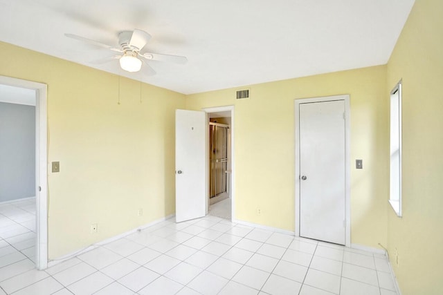 interior space featuring light tile patterned floors and ceiling fan