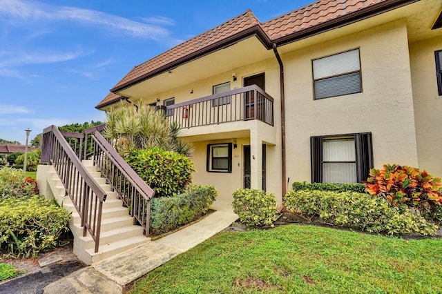 exterior space featuring a front yard and a balcony