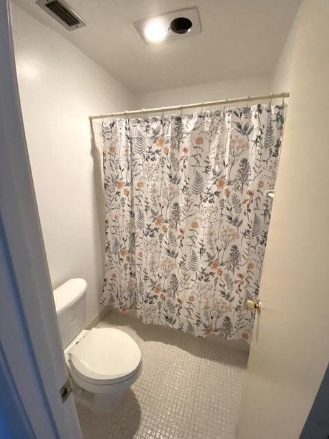 bathroom featuring tile patterned floors and toilet