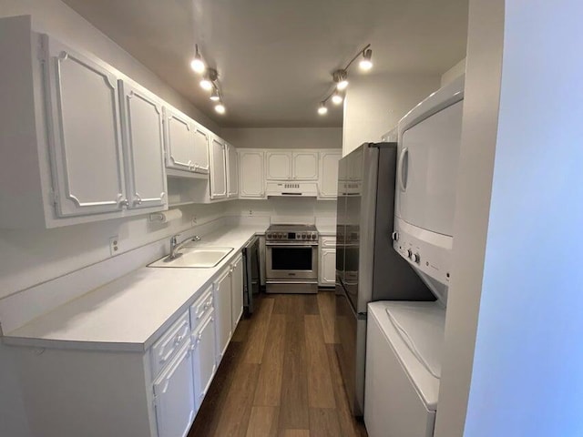 kitchen featuring dark hardwood / wood-style flooring, stainless steel gas range, sink, white cabinetry, and range hood