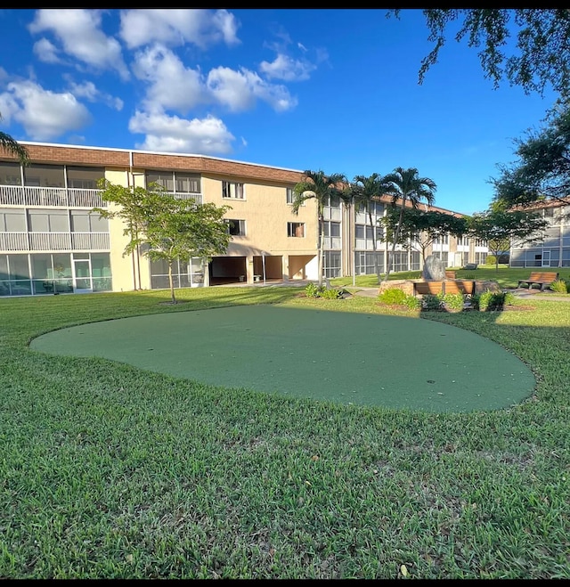 view of property's community with a lawn