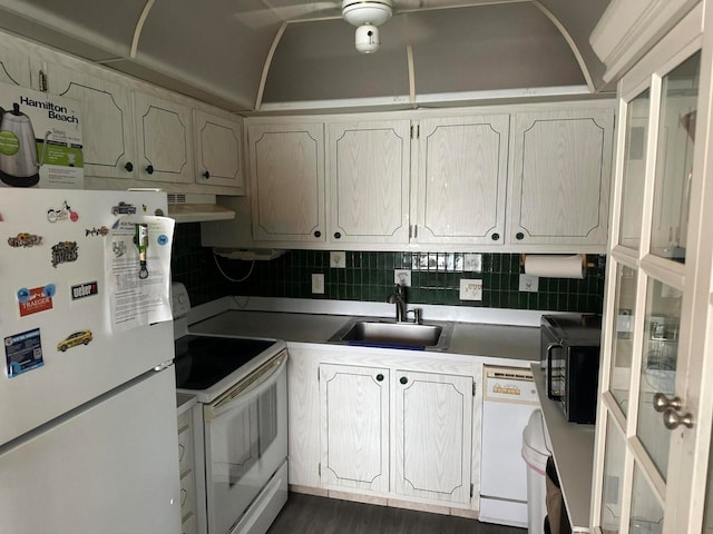 kitchen featuring range hood, dark hardwood / wood-style floors, decorative backsplash, sink, and white appliances